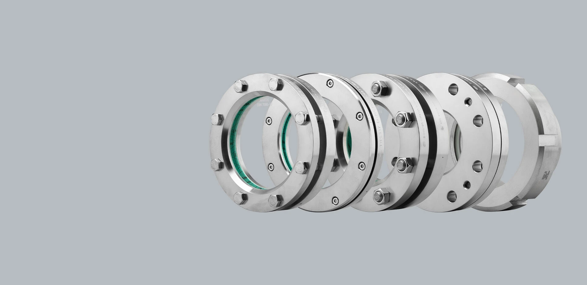 Image of several stainless steel flanges nested together.