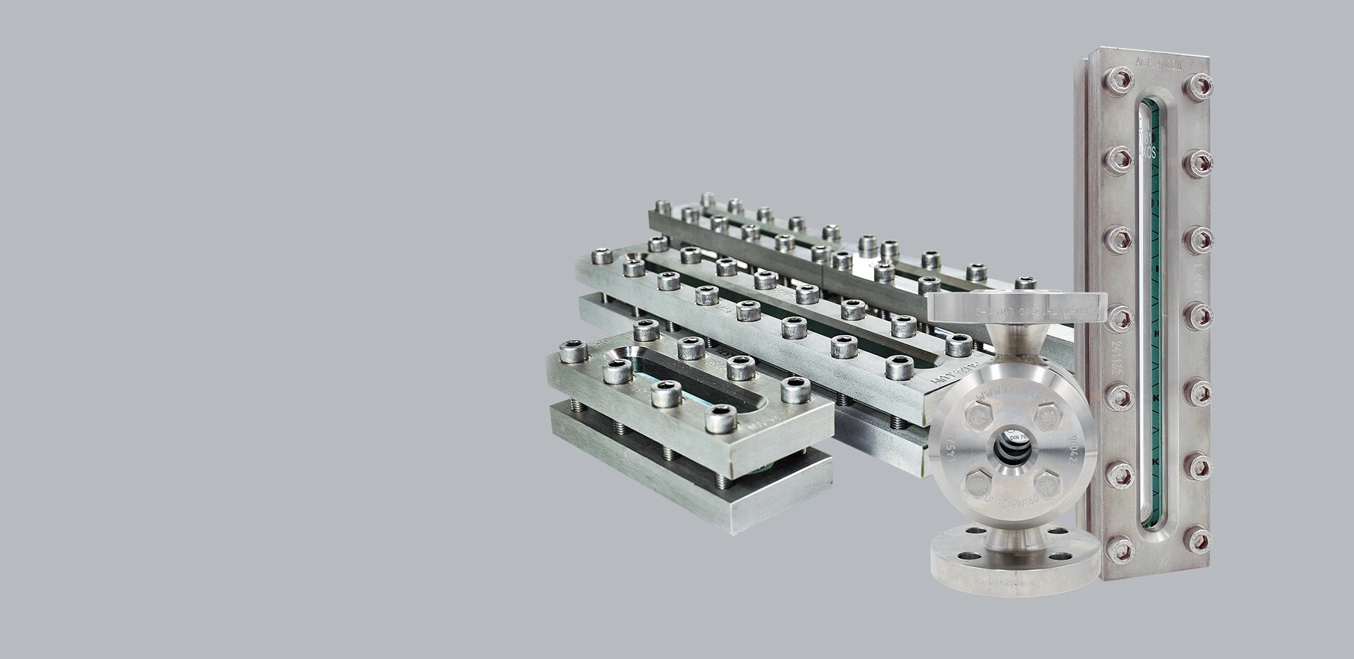 Stainless steel components, including plates, pipes, and a flange, on a gray background.