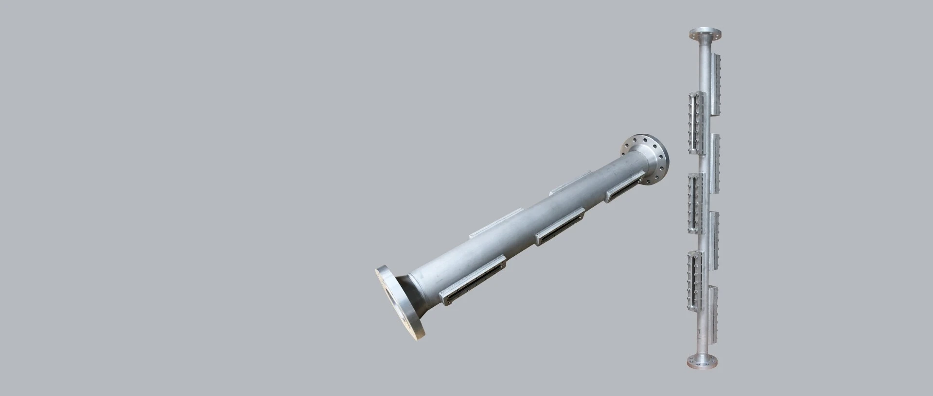 A metallic pipe structure with flanges and lateral elements.