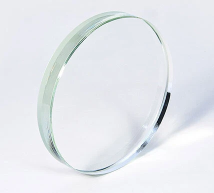 A transparent glass lens in a circular format.