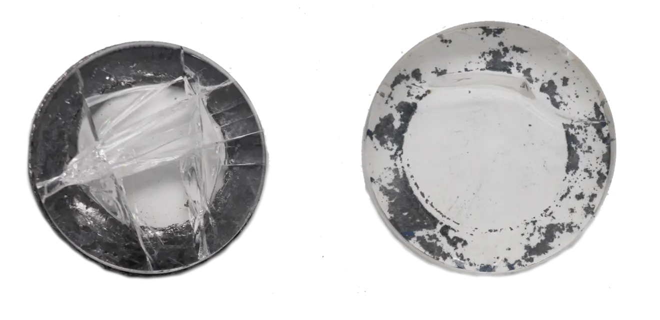 Two plates, one broken with visible cracks, the other undamaged with a darkened surface.