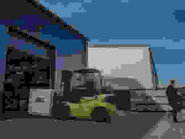A forklift is moving a pallet into the warehouse.
