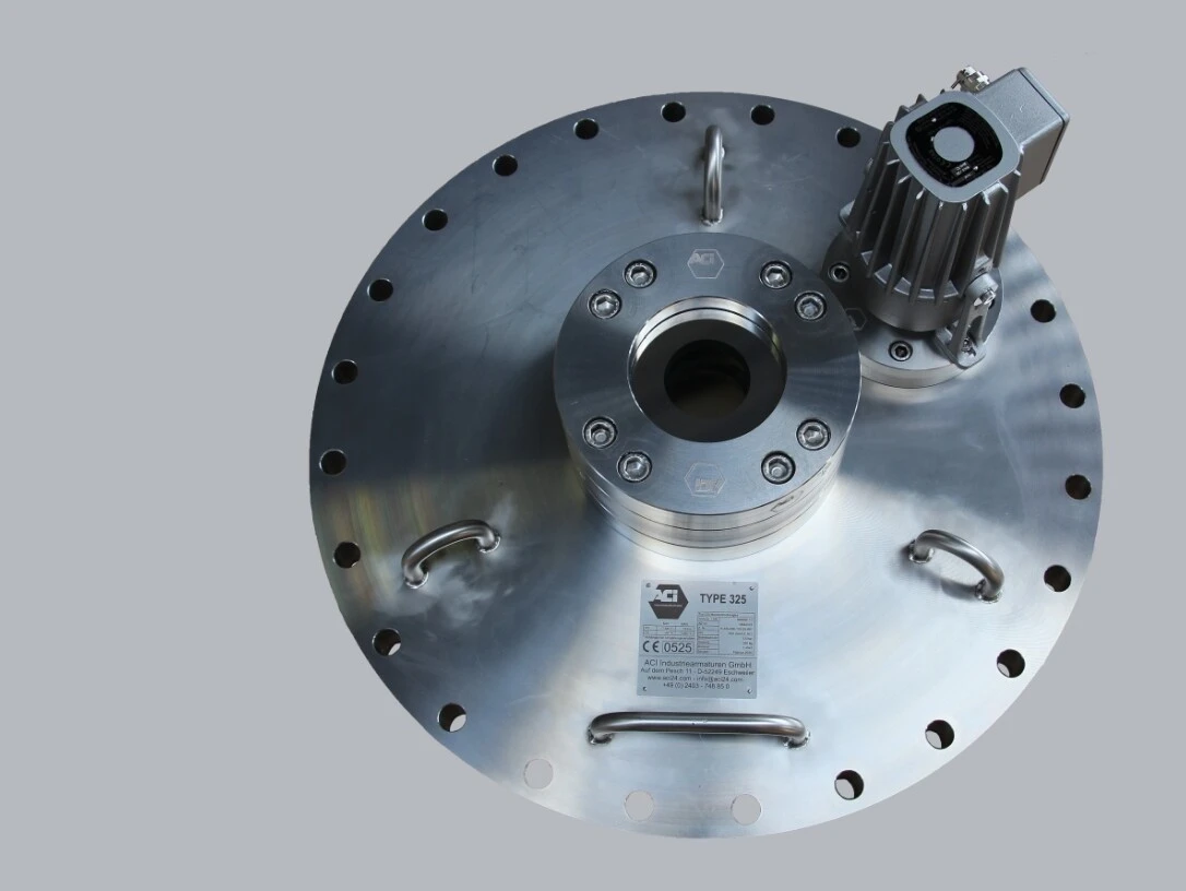 A metallic plate with a central hole, bolts, and a small motor device on top.