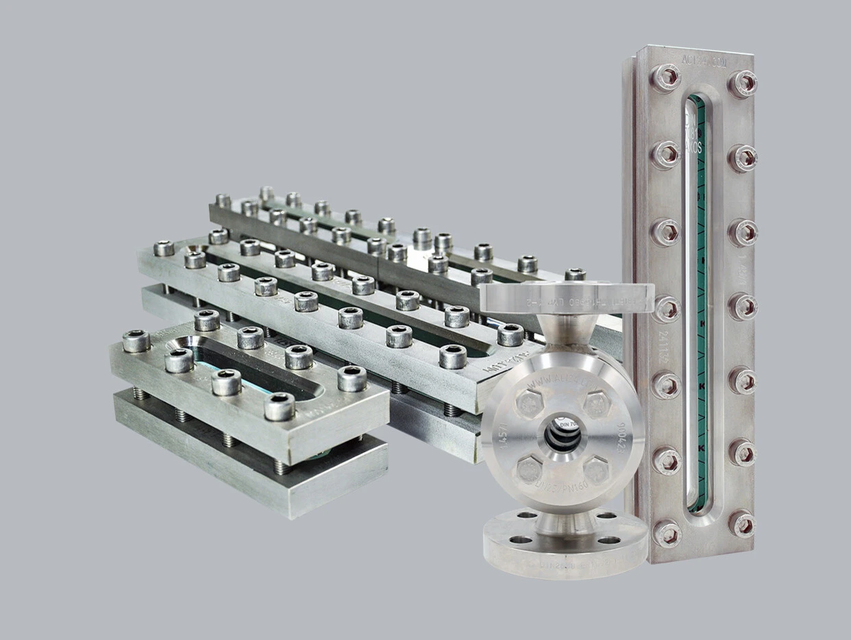 Stainless steel components, including plates, pipes, and a flange, on a gray background.
