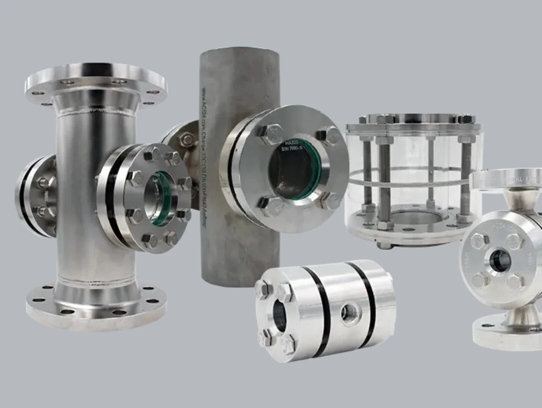 Various industrial stainless steel valves and components on a gray background.