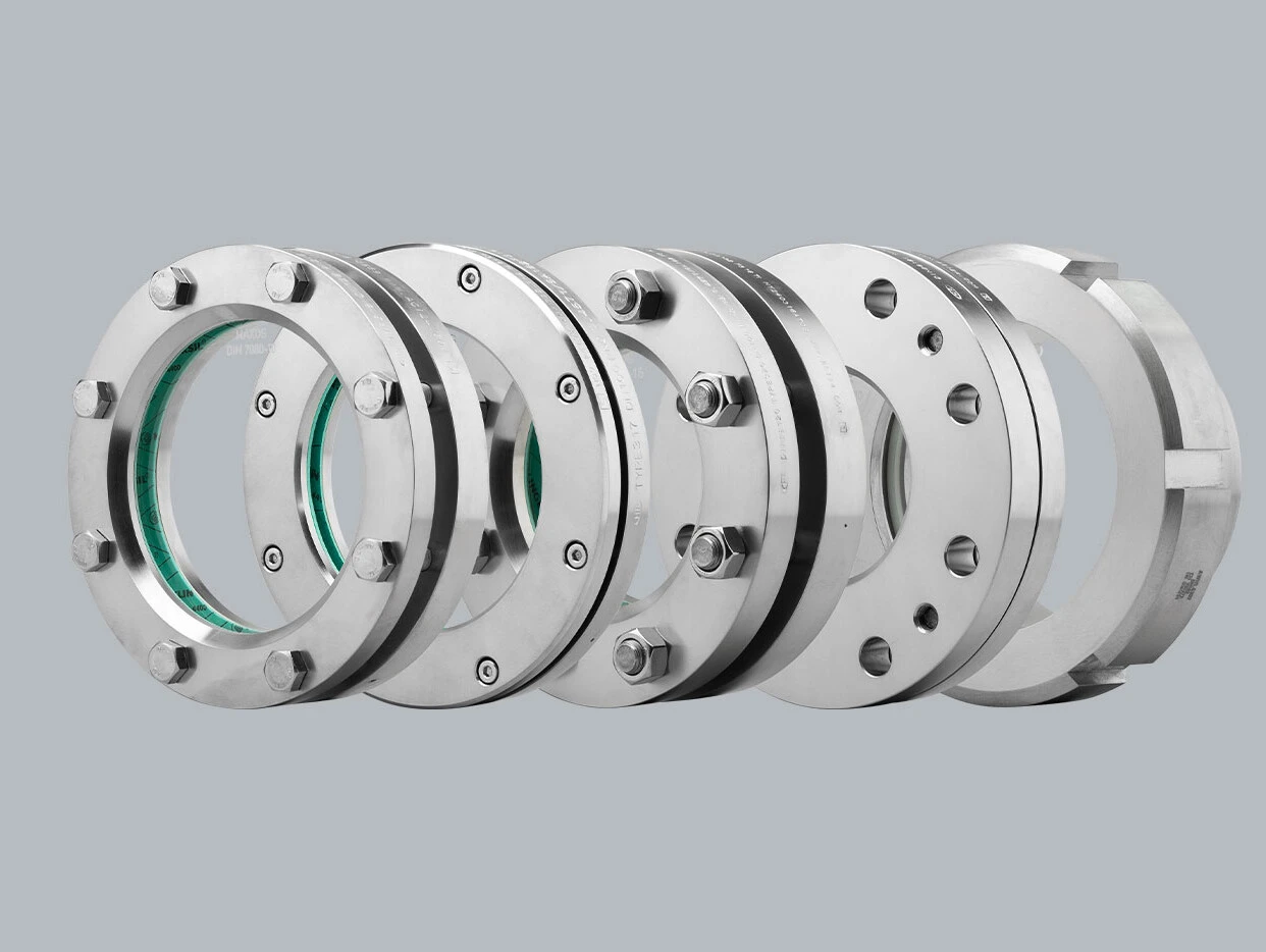 Image of several stainless steel flanges nested together.