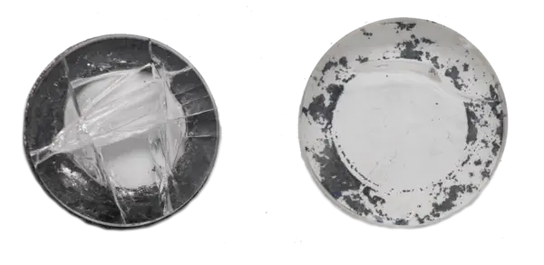 Two plates, one broken with visible cracks, the other undamaged with a darkened surface.