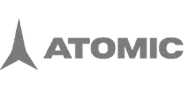 Logo firmy Atomic w szarej kolorystyce.